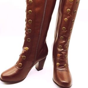 Synthetic, knee-high, zip-up boots.